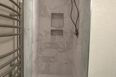 Small mountain style 3/4 multicolored tile and porcelain tile porcelain tile and brown floor alcove shower photo in Minneapolis with shaker cabinets, gray cabinets, a one-piece toilet, gray walls, an undermount sink, quartz countertops, a hinged shower door and gray countertops