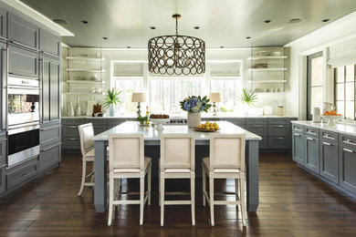 Large transitional u-shaped dark wood floor and brown floor kitchen photo in St Louis with an undermount sink, shaker cabinets, gray cabinets, marble countertops, white backsplash, marble backsplash, stainless steel appliances, an island and white countertops