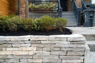 Photo of a small traditional full sun front yard stone landscaping in Toronto for fall.