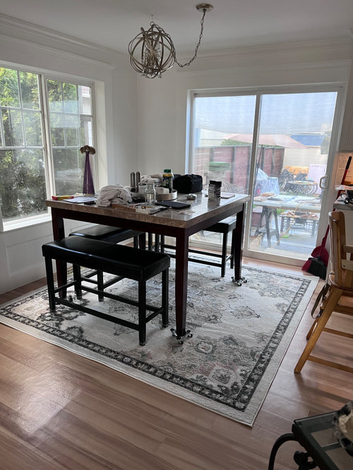 I can’t center dining table on area rug. Rug or no rug?
