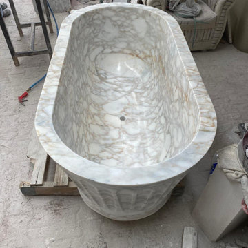 Sculptural Calacatta Gold Marble Bathroom with Hand-Carved Bathtub