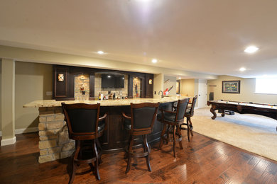 Wet bar - mid-sized rustic galley dark wood floor and brown floor wet bar idea in St Louis with dark wood cabinets, granite countertops, gray backsplash, stone tile backsplash and brown countertops