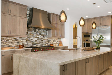 Kitchen - huge transitional l-shaped porcelain tile and beige floor kitchen idea in Tampa with an undermount sink, quartzite countertops, multicolored backsplash, glass tile backsplash, stainless steel appliances, an island, gray countertops, shaker cabinets and medium tone wood cabinets