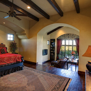 Bedroom - mediterranean dark wood floor bedroom idea in Austin with beige walls