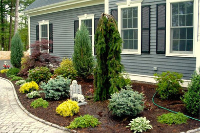 Design ideas for a mid-sized front yard full sun xeriscape in Boston with brick pavers.