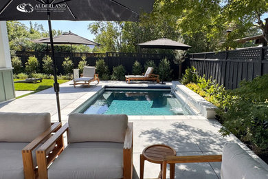 Example of a mid-sized trendy backyard stamped concrete and rectangular hot tub design in San Francisco