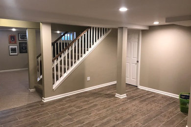 Mid-sized elegant look-out porcelain tile and brown floor basement photo in Chicago with beige walls