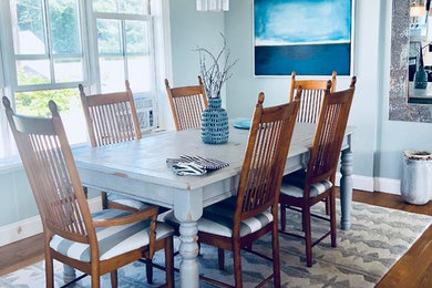 Inspiration for a mid-sized coastal medium tone wood floor and brown floor dining room remodel in Boston with blue walls and no fireplace