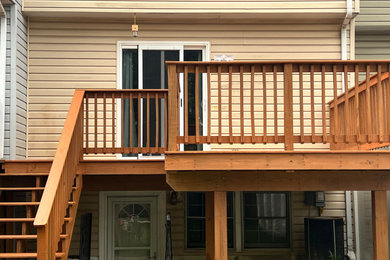 Inspiration for a mid-sized backyard wood railing deck remodel in Other with no cover