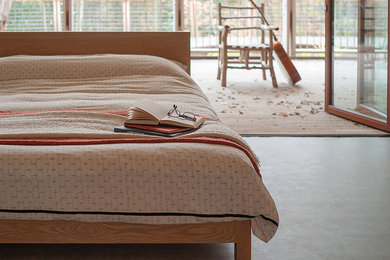Sonora Bed - A low wooden bed with a generous headboard