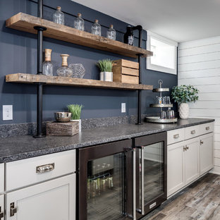 Photo of a small traditional look-out basement in Detroit with blue walls and laminate floors.