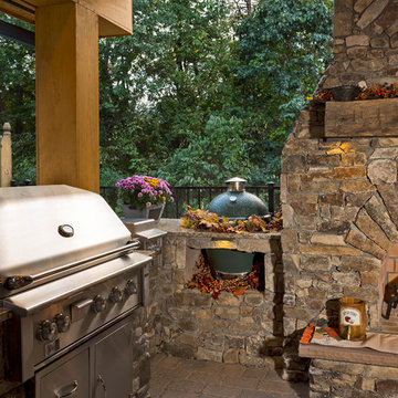 Outdoor fireplace with grill island and big green egg