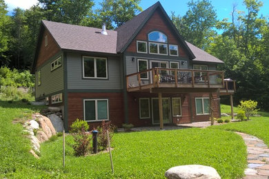 Inspiration for a mid-sized craftsman multicolored two-story mixed siding exterior home remodel in Burlington with a shingle roof