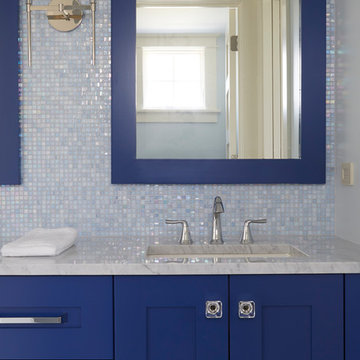 Blue Cabinets and Mirror in Guest Bathroom