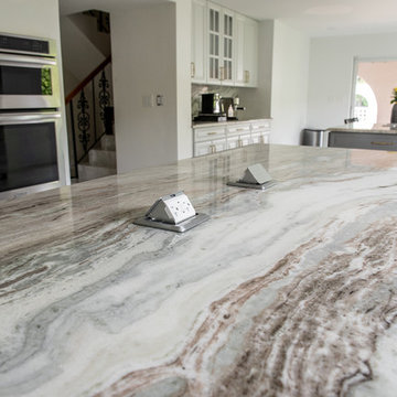 Transitional Kitchen Done in a 2 Tone Color With Integrated Dining Table