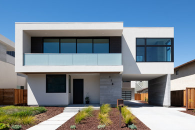 Large minimalist white two-story stucco exterior home photo in San Francisco with a metal roof and a white roof