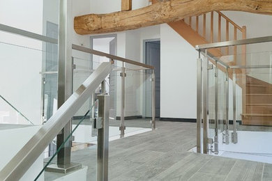 Inspiration for a mid-sized modern tile floating staircase in Paris with tile risers and metal railing.