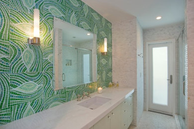 This is an example of a mid-sized traditional kids bathroom in Miami with flat-panel cabinets, an alcove shower, green tile, mosaic tile, mosaic tile floors, an undermount sink, engineered quartz benchtops, white floor and a hinged shower door.
