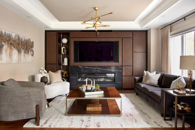Mid-sized contemporary formal enclosed living room in Toronto with beige walls, medium hardwood floors, a standard fireplace, a built-in media wall, brown floor, recessed and a tile fireplace surround.
