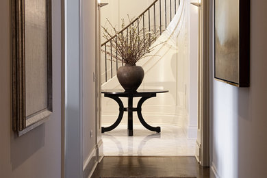 Transitional hallway in Chicago with white walls and medium hardwood floors.