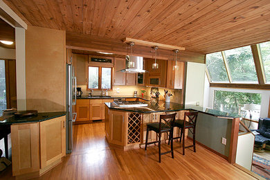 Inspiration for a small transitional l-shaped porcelain tile eat-in kitchen remodel in Other with shaker cabinets, light wood cabinets, granite countertops, beige backsplash, glass tile backsplash, stainless steel appliances and a peninsula