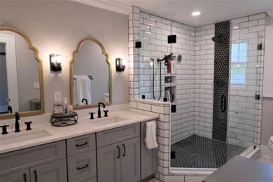Corner shower - large modern master white tile and ceramic tile cement tile floor, white floor and double-sink corner shower idea in Other with shaker cabinets, gray cabinets, gray walls, an undermount sink, quartz countertops, a hinged shower door, white countertops, a niche and a built-in vanity