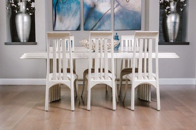 Light wood floor and brown floor dining room photo in Chicago with white walls and no fireplace