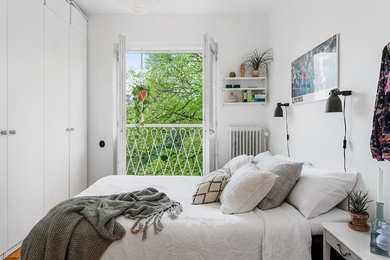 Photo of a scandinavian master bedroom in Stockholm with white walls.