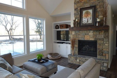 Minimalist loft-style dark wood floor living room photo in Minneapolis with beige walls, a standard fireplace and a stone fireplace