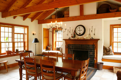 Cottage kitchen/dining room combo photo in Philadelphia with white walls, a standard fireplace and a tile fireplace