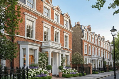 Photo of a large and red terraced house in London.