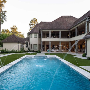 Rectangular pool, covered patio and kitchen, outdoor shower, landscaping