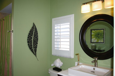 Small transitional bathroom photo in Tampa with recessed-panel cabinets, dark wood cabinets and solid surface countertops