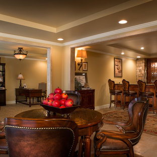 Photo of a large classic walk-out basement in Atlanta with beige walls, travertine flooring and a standard fireplace.
