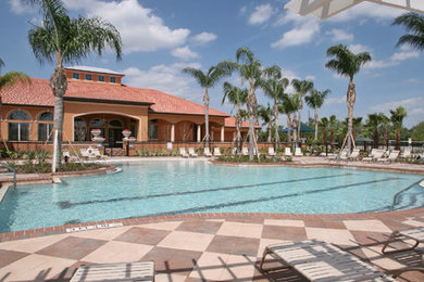 Inspiration for a coastal courtyard concrete paver patio fountain remodel in Orlando with a pergola