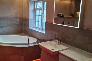 Large contemporary ensuite bathroom in Other with flat-panel cabinets, white cabinets, a walk-in shower, beige tiles, marble worktops, grey worktops and double sinks.