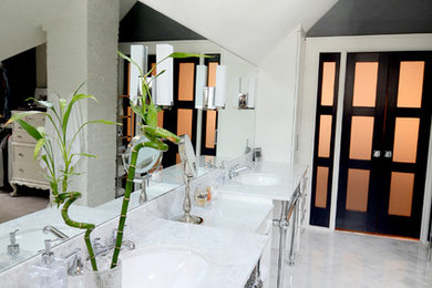 Example of a large transitional master marble floor and white floor alcove shower design in Atlanta with recessed-panel cabinets, white cabinets, a one-piece toilet, an undermount sink, marble countertops, white walls and a hinged shower door