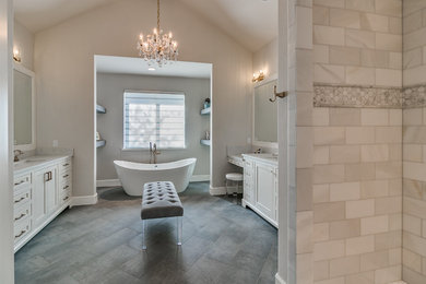 Design ideas for a large country master wet room bathroom in Oklahoma City with beaded inset cabinets, white cabinets, a freestanding tub, a one-piece toilet, white tile, marble, beige walls, porcelain floors, an undermount sink, marble benchtops, grey floor and an open shower.