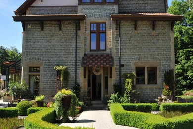 Elegant three-story stone gable roof photo in Other