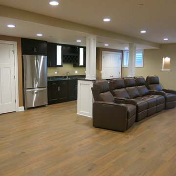 Roselle basement with full bar, media area, and gym with barn door