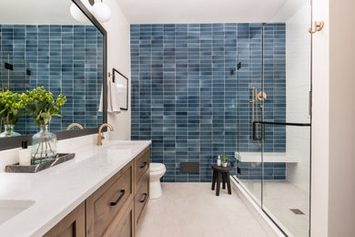 Alcove shower - small transitional master blue tile and ceramic tile mosaic tile floor, beige floor and double-sink alcove shower idea in Chicago with recessed-panel cabinets, medium tone wood cabinets, a one-piece toilet, white walls, a drop-in sink, quartz countertops, a hinged shower door, white countertops and a floating vanity