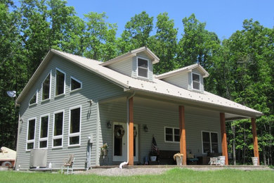 Inspiration for a mid-sized craftsman gray two-story wood exterior home remodel in Other with a metal roof