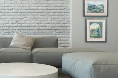 Brick wall living room photo in Miami with gray walls
