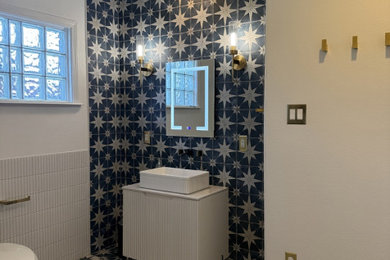Inspiration for a mediterranean multicolored tile and cement tile multicolored floor and single-sink bathroom remodel in Other with white cabinets, a one-piece toilet, multicolored walls, a vessel sink, quartz countertops, white countertops and a freestanding vanity