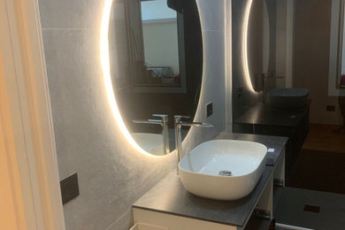 Example of a minimalist master bathroom design with flat-panel cabinets and a floating vanity