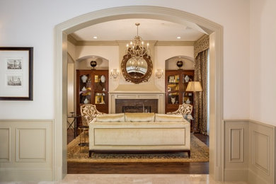 Mid-sized elegant formal and open concept medium tone wood floor living room photo in Los Angeles with beige walls, a stone fireplace and no tv