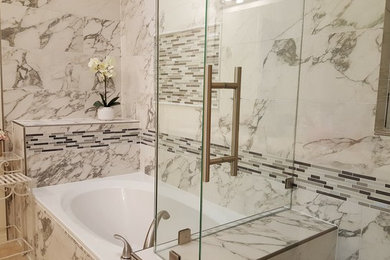 This is an example of a mid-sized transitional master bathroom in Austin with a corner shower, white tile, stone tile, white walls and travertine floors.