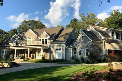 Example of a gray two-story stone exterior home design in Other with a shingle roof