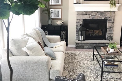 Living room - large transitional open concept carpeted and gray floor living room idea in Minneapolis with beige walls, a standard fireplace, a stone fireplace and a wall-mounted tv