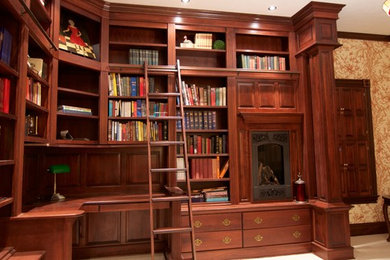 Inspiration for a large timeless built-in desk carpeted study room remodel in Other with multicolored walls and a standard fireplace